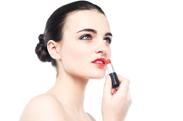 istock Young gorgeous woman applying lipstick 485631047
