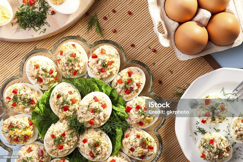 stuffed eggs with ham, red pepper and dill stuffed eggs with ham, red pepper and dill on plate Animal Egg Stock Photo