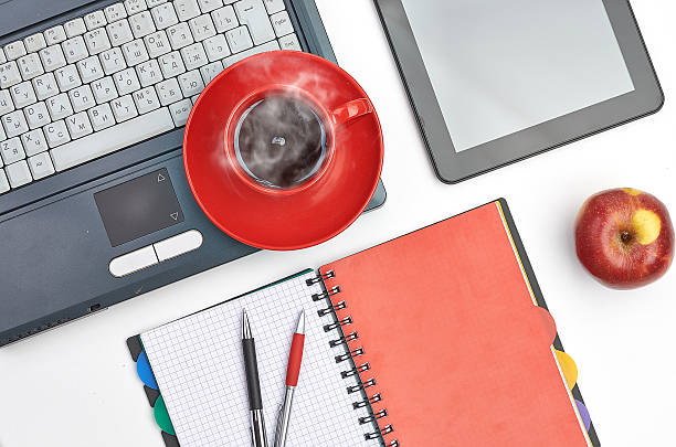 istock Laptop and office supplies on white 485633871