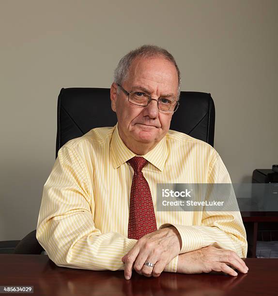 Serious Senior Businessman Stock Photo - Download Image Now - Businessman, Desk, Impatient