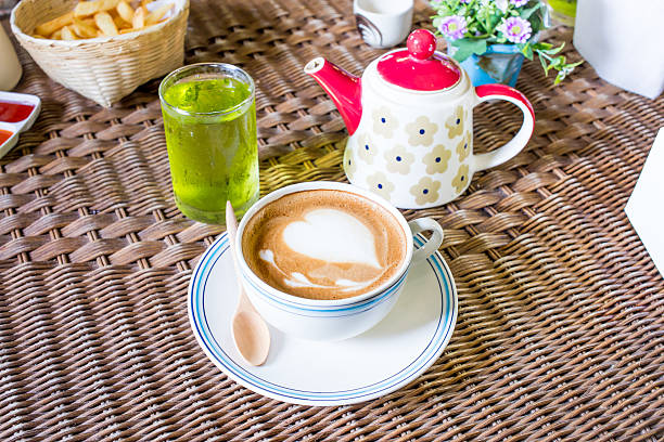 istock Cup of coffee on a table with flowers 485634860