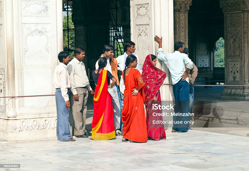 An Indian family and crowds at the Hall of Audience Delhi, India - November 9, 2011: Indian family visits the the Hall of Audience  in the Red Fort in  Delhi, India. The red Fort is visited by more than 3  million indian tourists yearly.. Adult Stock Photo