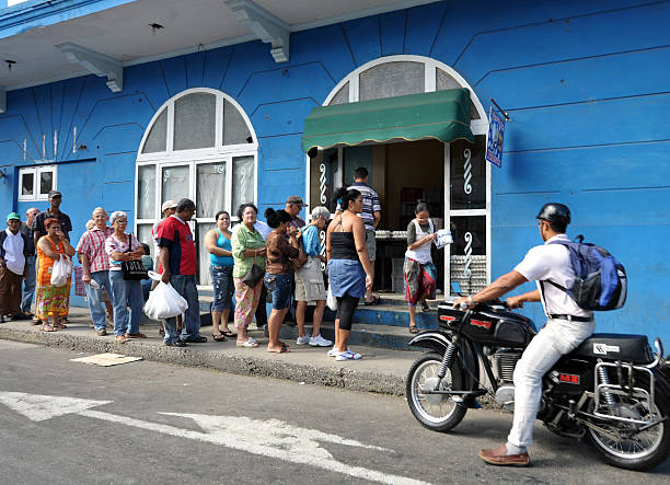Havana, Cuba, October 30th 2012, despite a general slow recovery in the economy as reliance moves away from agriculture towards tourism, severe food shortages nevertheless remain as witnessed by this queue for eggs in suburban Havana.