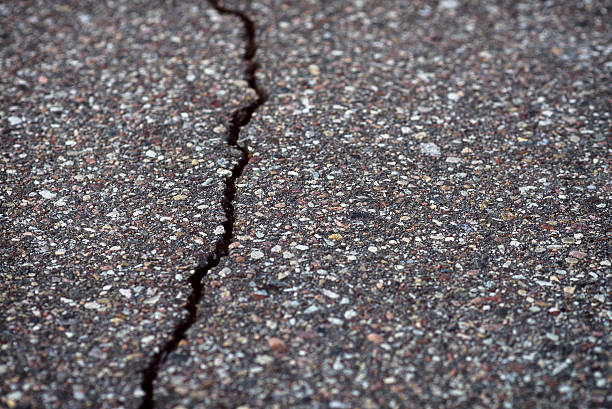 Close-Up texture of damaged asphalt road surface with cracks