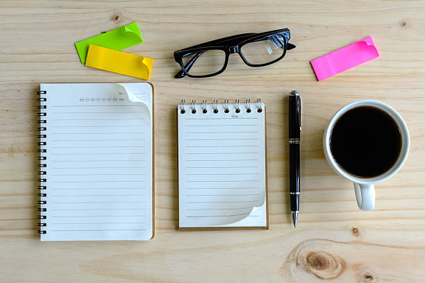 istock Cup of coffee with blank notebook on wooden desk 485638694