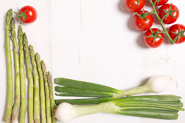 istock Fresh asparagus tomatoes and spring onions 485641736