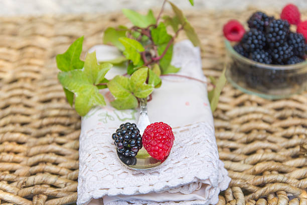blackberries and raspberries with spoon. stock photo