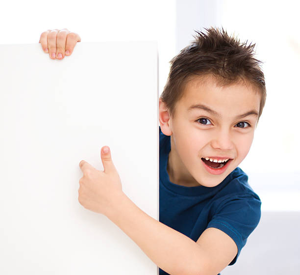 istock Cute boy is holding blank banner 485650173
