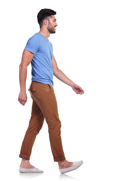 istock side view of a casual man walking forward and smiling 485650447
