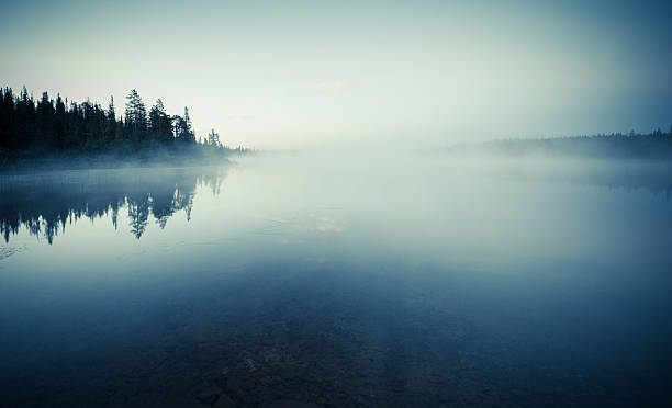 Mysterious lake before dawn stock photo