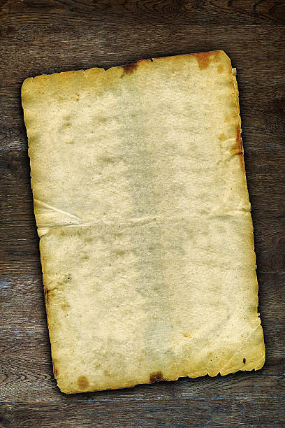 istock Old grunge paper on brown wooden surface with natural patterns 485651535