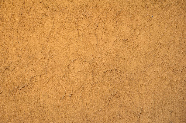 istock Texture of old wall covered with yellow stucco 485652884