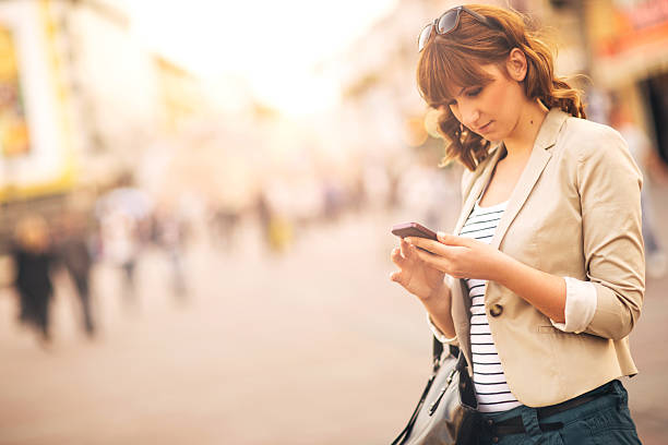 istock Woman using a smartphone outdoors 485653111