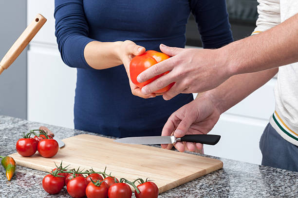 istock Couple cutting vegatables 485653337