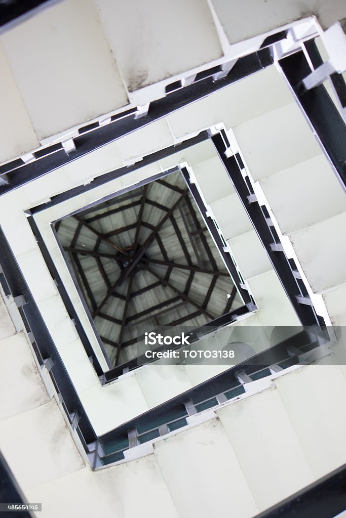 Square spiral staircase Low angle view of square spiral staircase Abstract Stock Photo