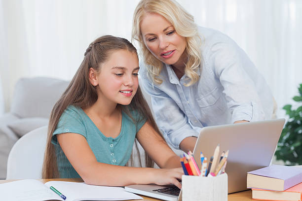 istock Mother helping her daughter to do homework 485654879