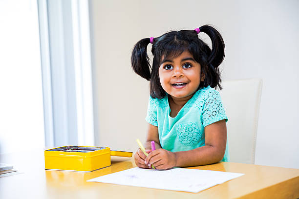 istock Cute little girl drawing with crayons 485654983