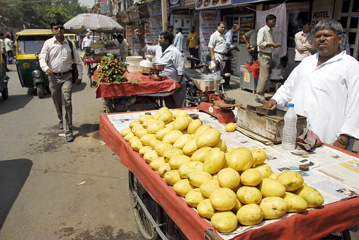 New Delhi, India - May 23rd, 2009: Unidentified street vendor sells mangoes on a Main Bazaar street on May 23, 2009 in New Delhi, India.