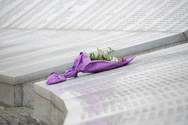 At the Srebrenica Genocide Memorial, also called the "Srebrenica-Potočari Memorial and Cemetery for the Victims of the 1995 Genocide", flowers left by a visitor lay on the names of some of the more than 6000 Bosnian Muslims killed by Bosnian Serbs in the Srebrenica area in July 1995.