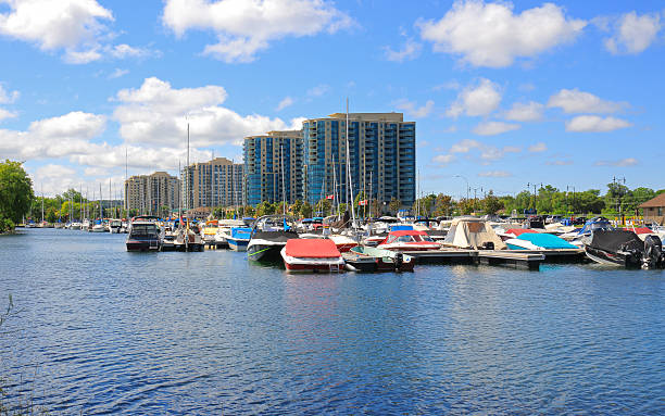 Barrie, Сanada - August 12, 2015: Marina with boats and yachts in kempenfelt bay, Lake Simcoe, waterfront condominium Buildings under blue sky and white clouds