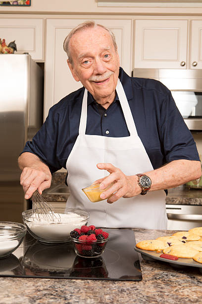 istock Senior Citizen Man cooking in kitchen 485657035