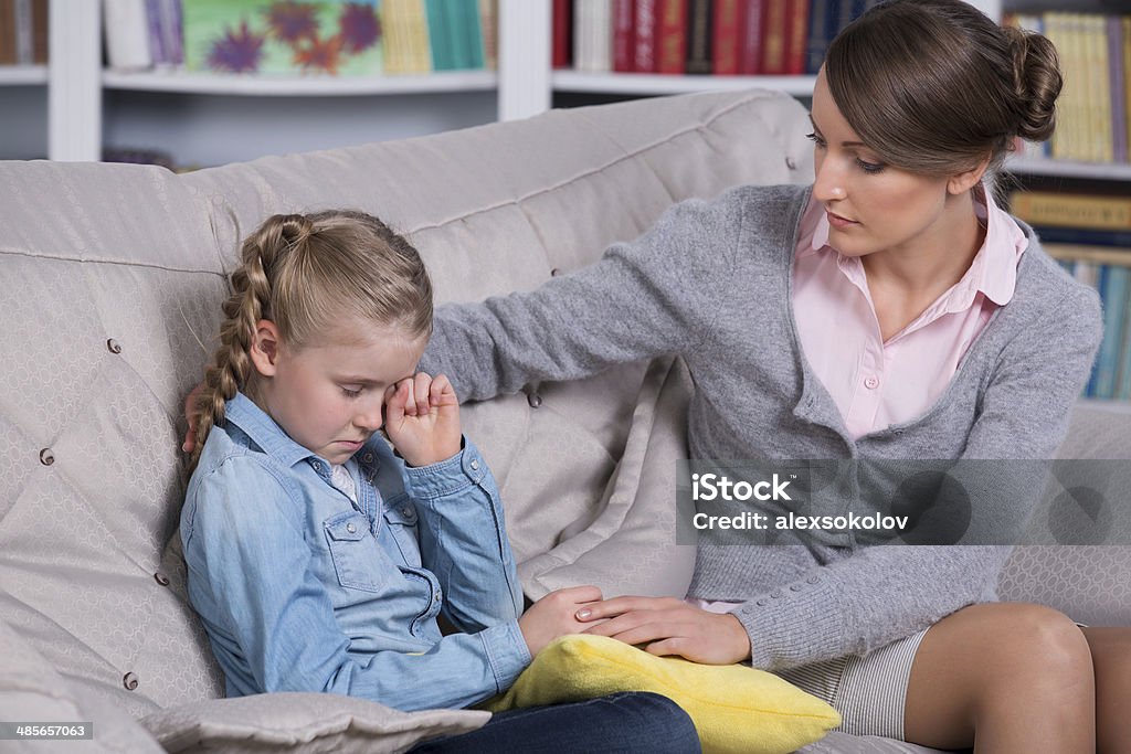 psychiatrist's therapy Child psychologist with a little girl, a child is crying Adult Stock Photo