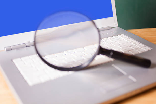istock Business concepts. Round magnifying glass on laptop computer keyboard. 485658650