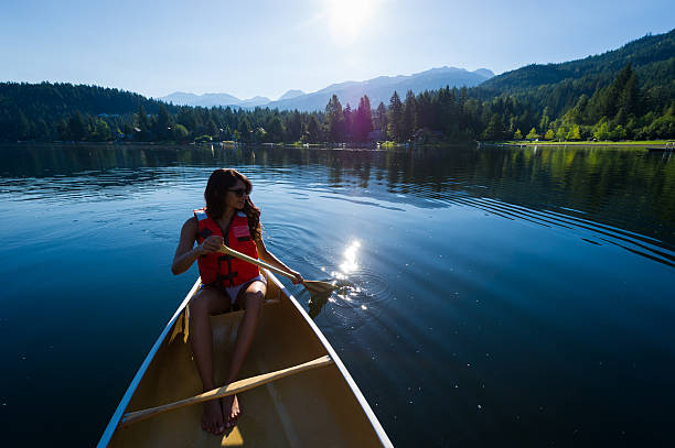 istock Female canoeing on a prisitine lake 485662670