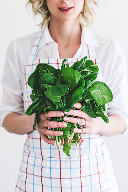 istock Young woman with fresh spinach 485663706