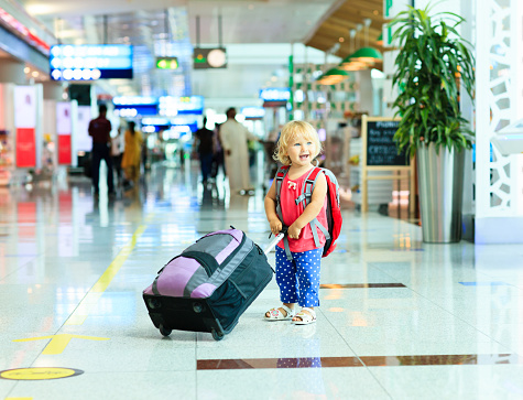 little girl with suitcase travel in the airport, kids travel
