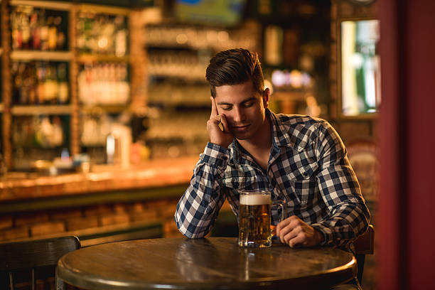 istock Young pensive man sitting alone in a bar. 485670488