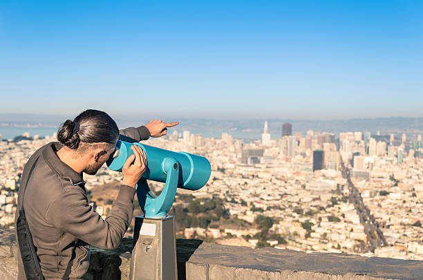 Mature man looking at view with a binoculars outdoors