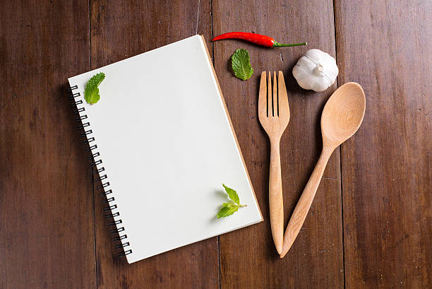 istock Recipe notebook, garlic, spoon, fork on wooden background 485671468