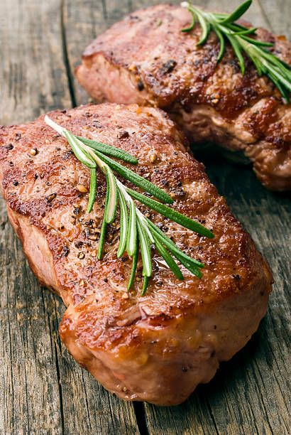 istock Beef steak on a wooden table 485673189