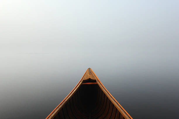 istock Canoe bow in thick mist and calm waters 485673373