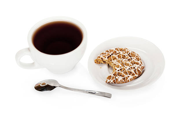 istock Cup of tea and a coockie isolated on white 485673763