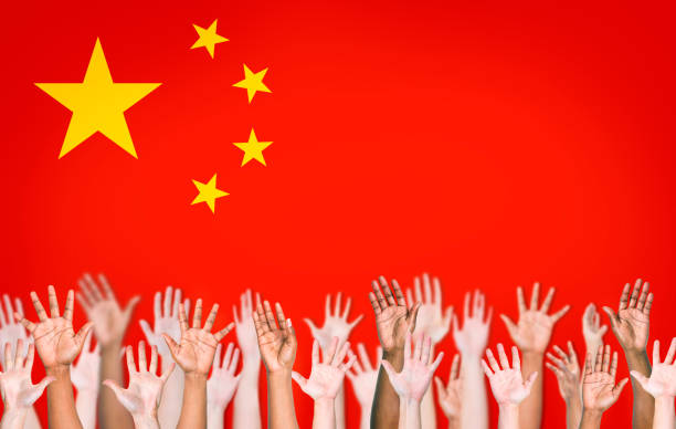 istock People's Hands Raised with Chinese Flag on the Background 485675309