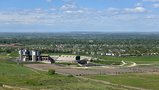 Fort Collins, Colorado, USA - May 30, 2013: High angle view of Hughes Stadium with Fort Collins in the background. Hughes Stadium is a football stadium and home to the Colorado State Rams.