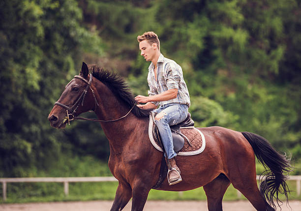 istock Smiling man enjoying horseback riding. 485675938