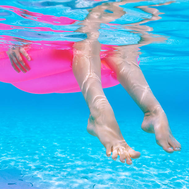 istock Woman relaxing on inflatable mattress, view from underwater 485676261