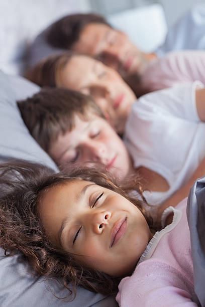 istock Family sleeping in bed 485677249
