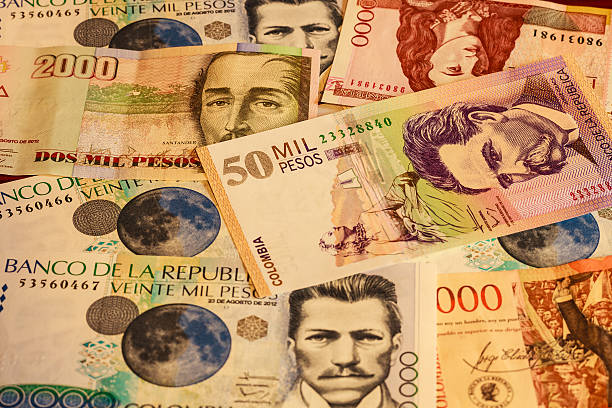 Colombia Money - paper currency fills the screen Colombian paper currecncy fills the camera screen. There is a 50,000 Peso note with some 20,000 a 10,000, 2000 and 1000 Peso notes.  Photo shot in studio environment; horizontal format.  Focus on 50,000 Peso note. colombian peso stock pictures, royalty-free photos & images