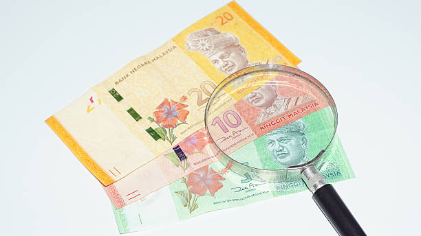 istock Magnifier with Malaysia bank notes.concept photo 485679798