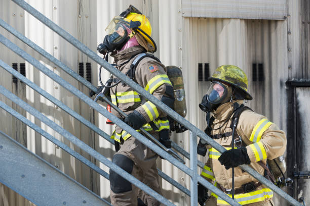 istock Two firefighters in protective gear climbing stairs 485687362