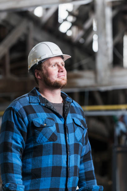 istock Man in industrial building wearing hardhat 485687414