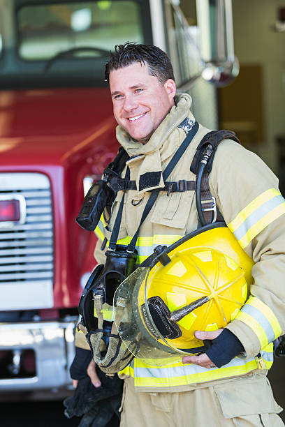 istock Firefighter in protective suit by fire truck 485691404