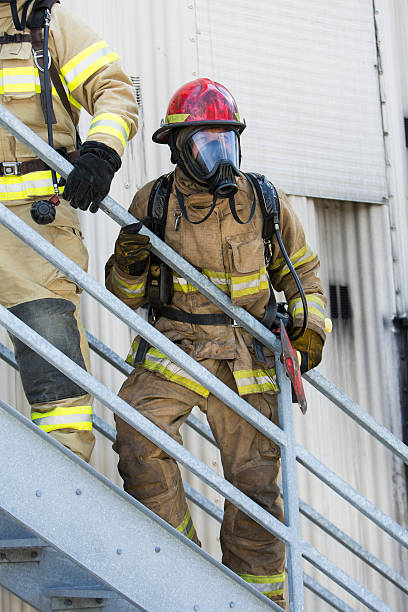 istock Firefighters climbing stairs outside industrial building 485696322