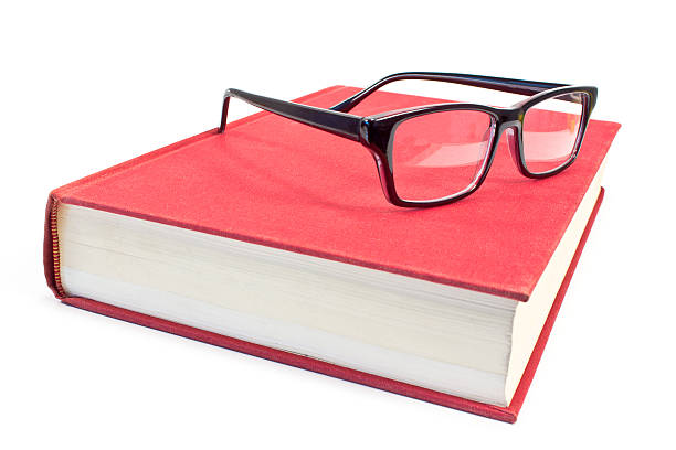 istock Eyeglasses and book isolated on white 485696778
