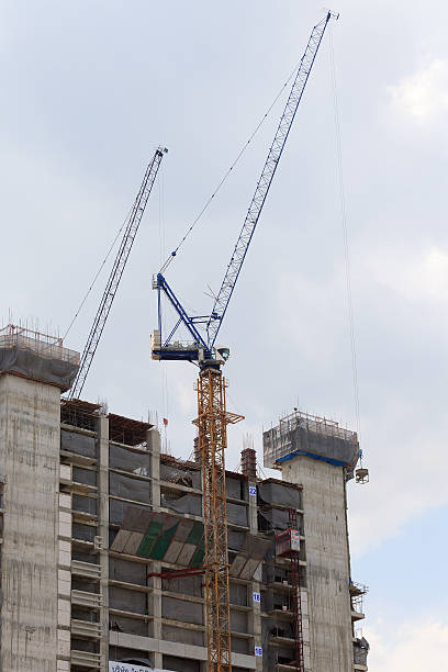 istock Crane and buildings are in construction site. 485697434