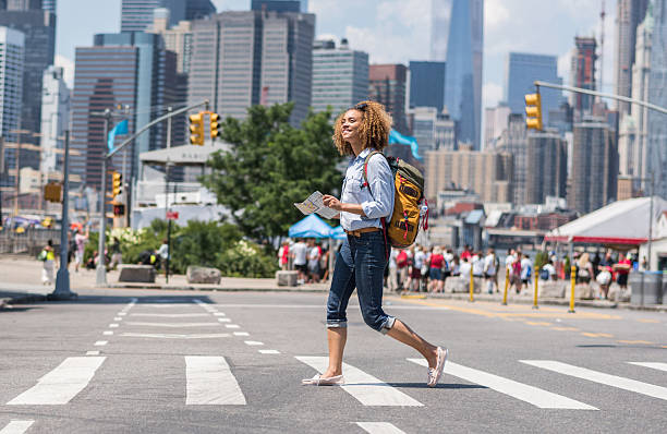 African American woman tourist holding a map in New York Happy African American woman tourist holding a map in New York - people traveling concepts student travel stock pictures, royalty-free photos & images